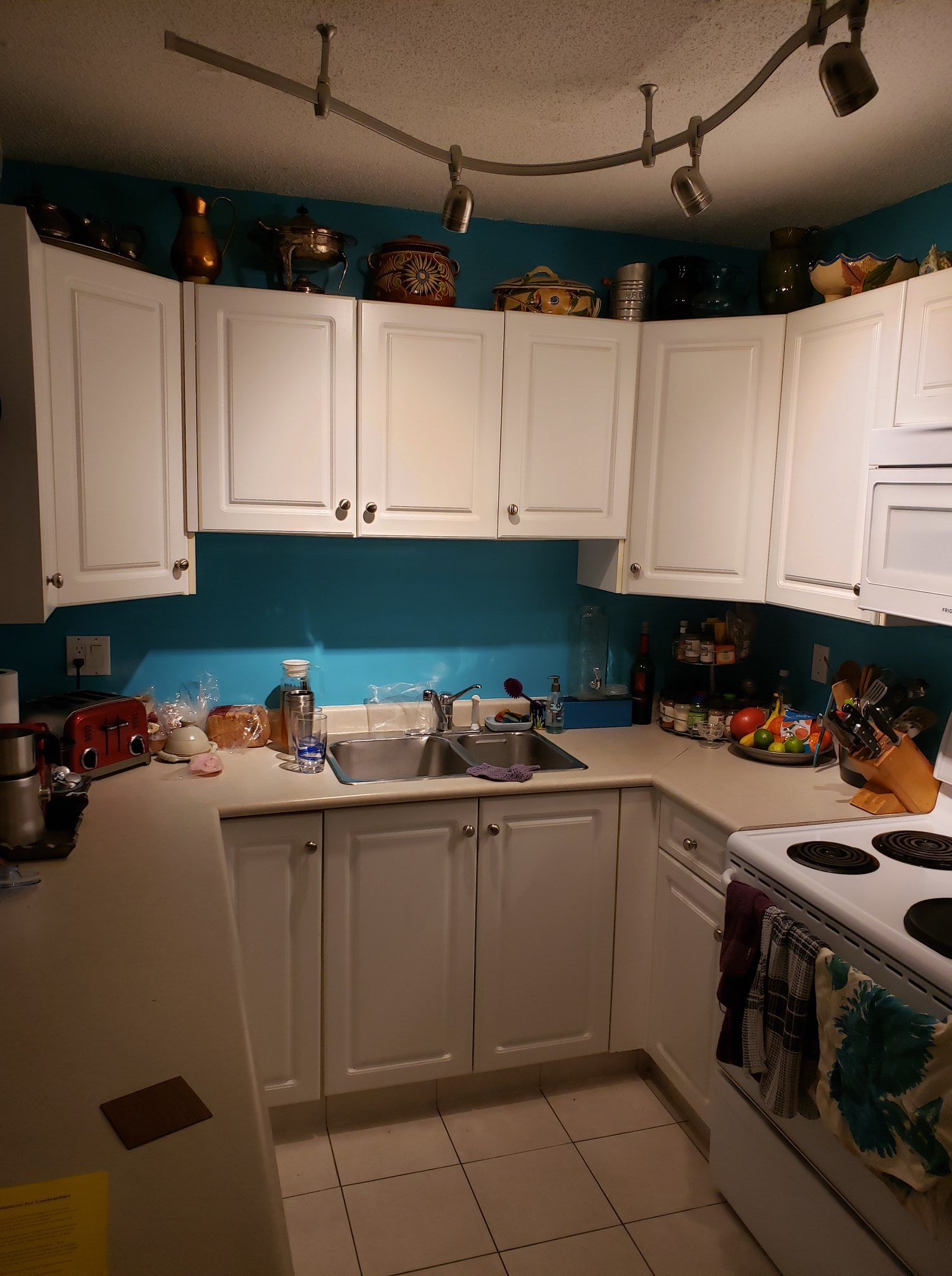 Before and after of modern kitchen renovation with cabinets, countertops and fixtures.